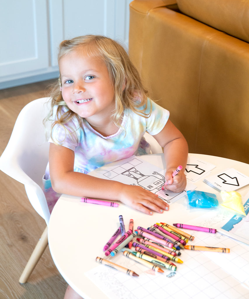 Girl coloring a robot coloring page
