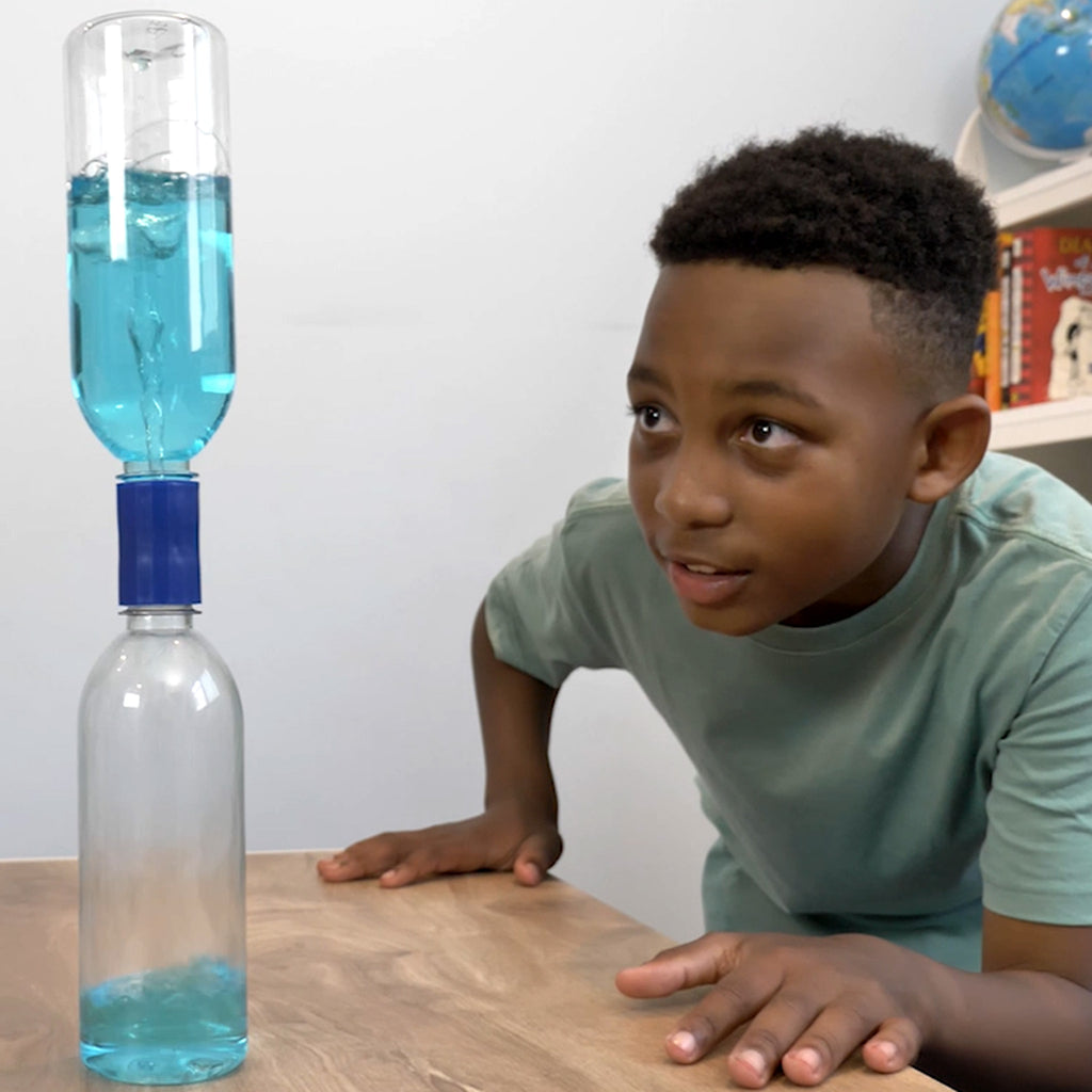 young boy performing tornado bottle experiment