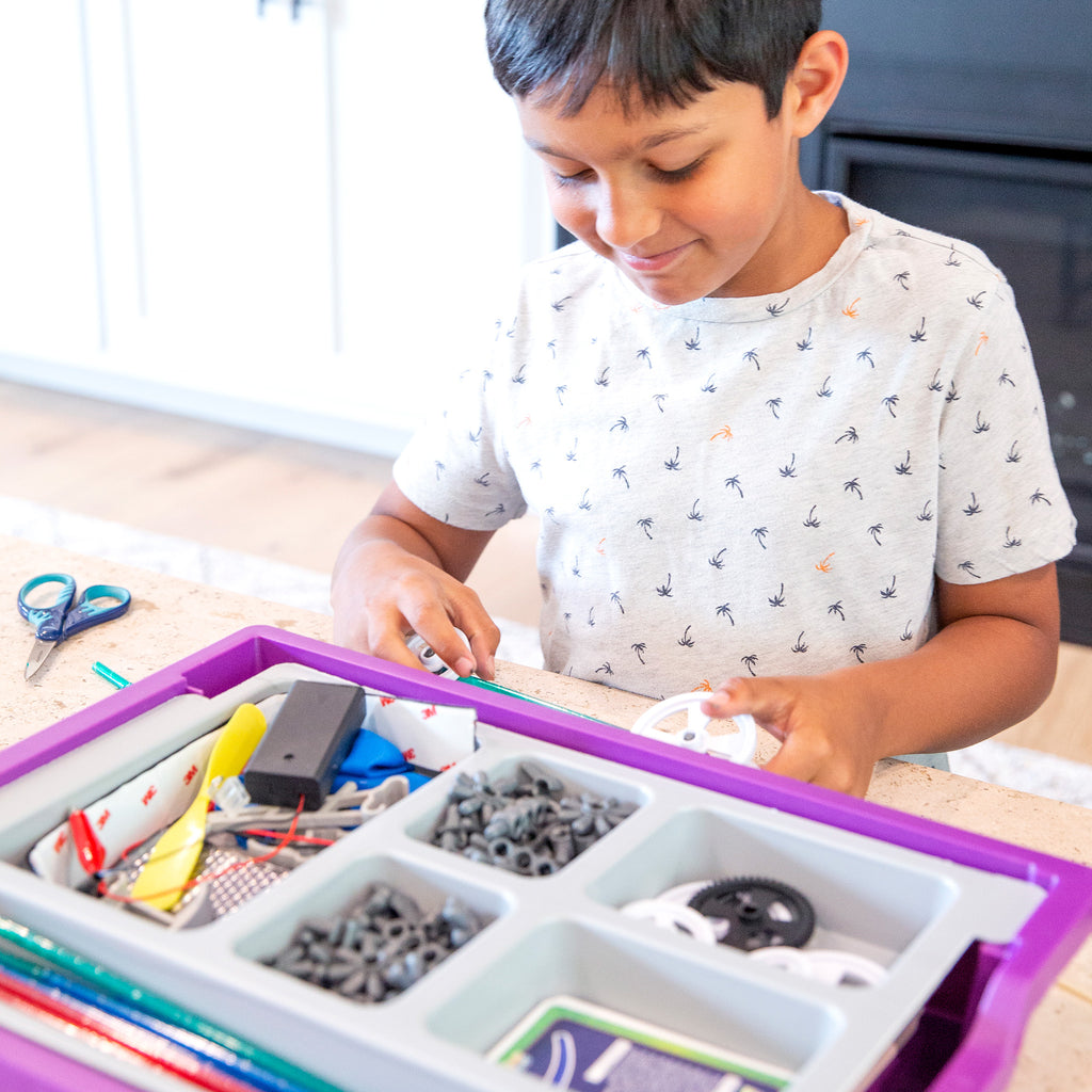 Young boy learns STEM through activity kit