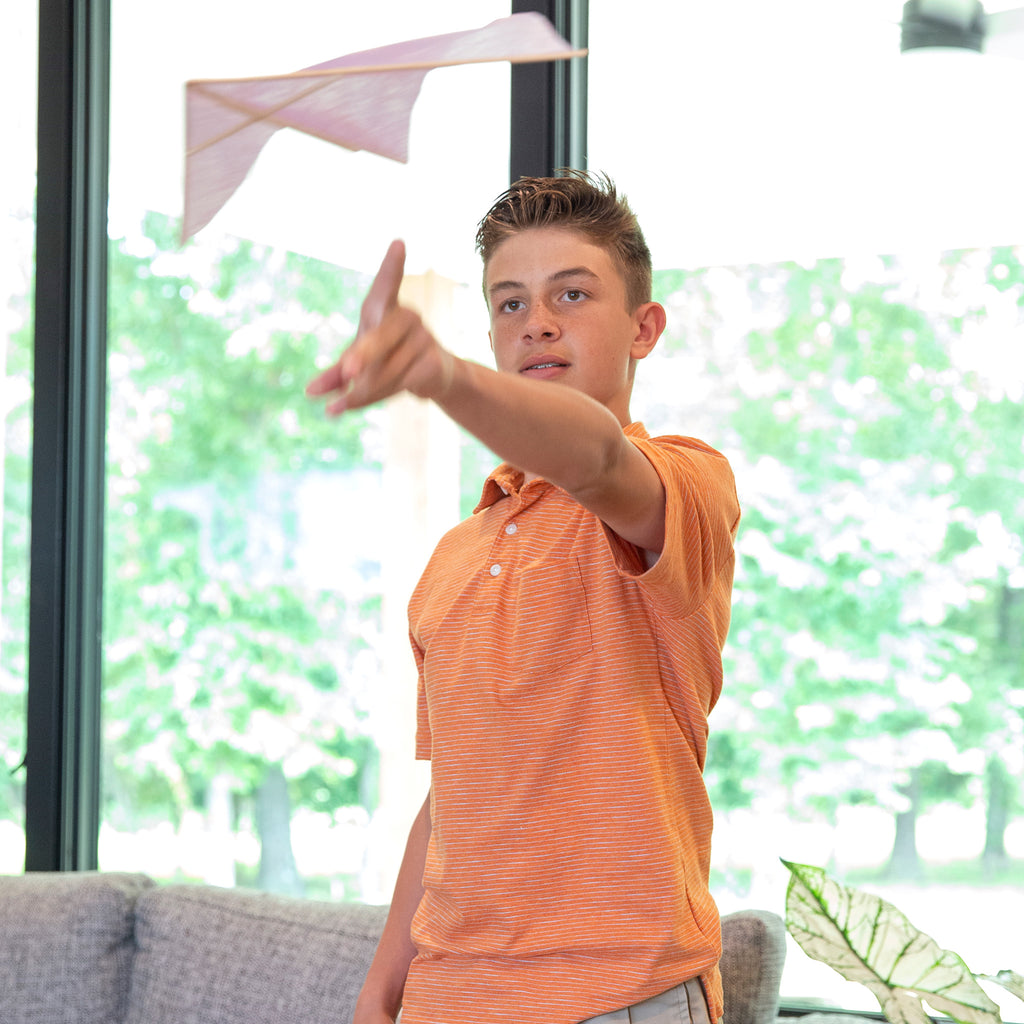 Young boy learns physic through paper airplanes