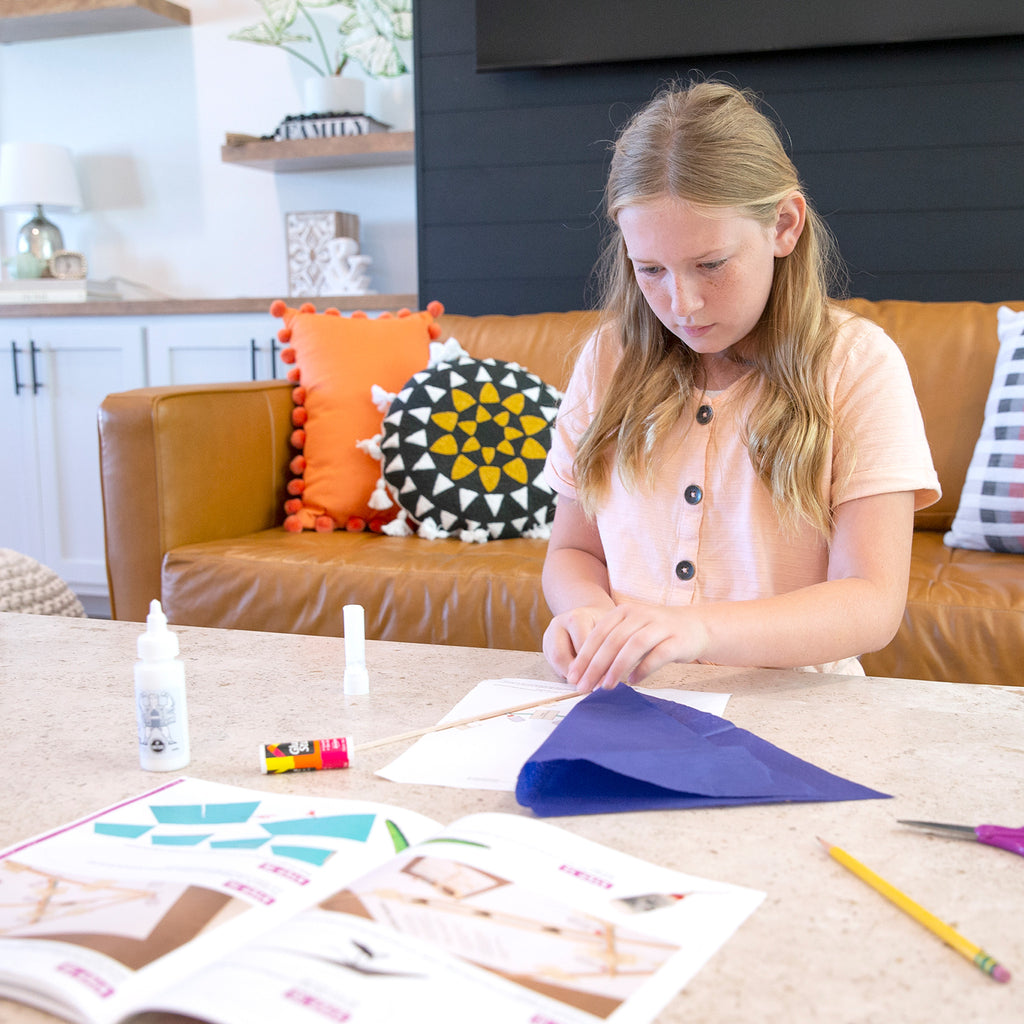Young girl learns about physics through educational homeschool activity