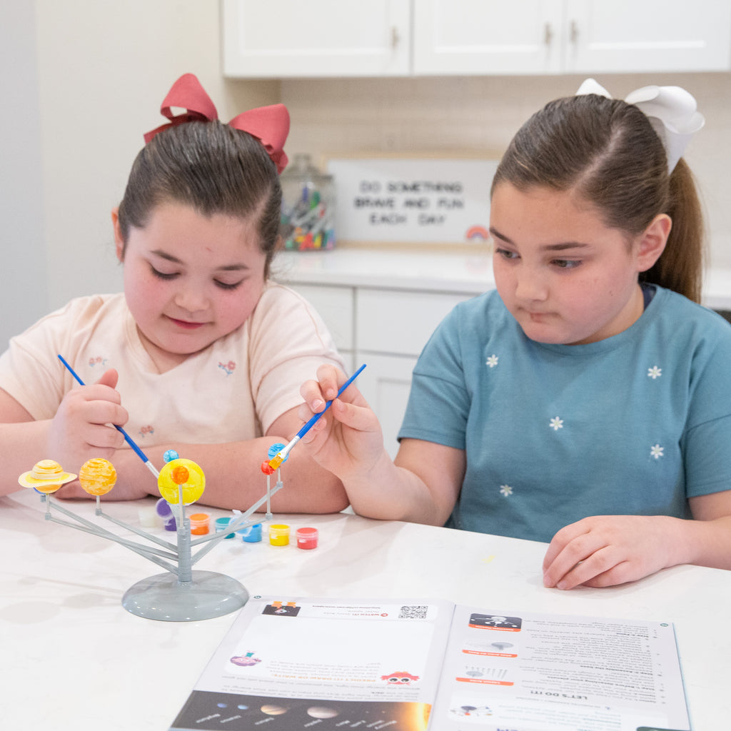 Young girls learn about the solar system